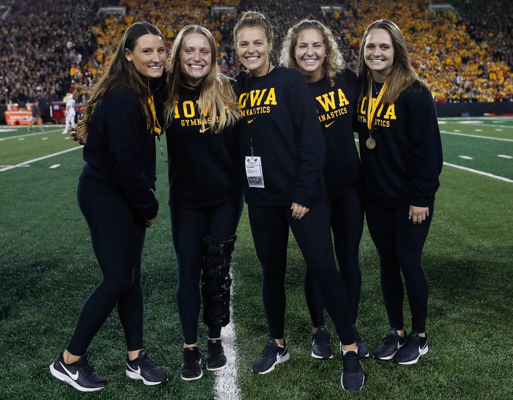 Members of the Iowa women's gymnastics team are recognized by the Presidential Committee on Athletics at halftime during a game against Wisconsin on September 22, 2018. (Tork Mason/hawkeyesports.com)