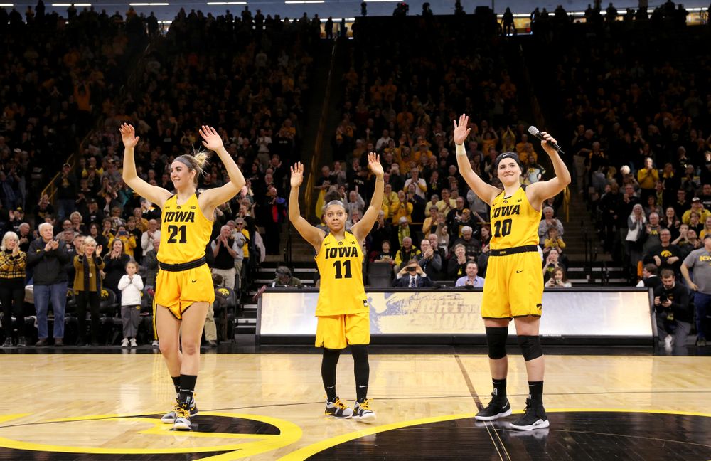 Iowa Hawkeyes seniors Hannah Stewart, Tania Davis, and Megan Gustafson wave to the fans during senior day ceremonies following their game against the Northwestern Wildcats Sunday, March 3, 2019 at Carver-Hawkeye Arena. (Brian Ray/hawkeyesports.com)