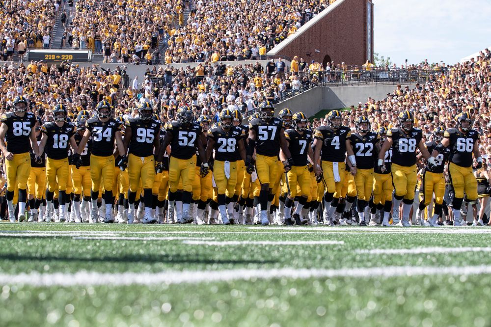 The Iowa Hawkeyes swarm onto the field for their game against the Rutgers Scarlet Knights Saturday, September 7, 2019 at Kinnick Stadium. (Brian Ray/hawkeyesports.com)