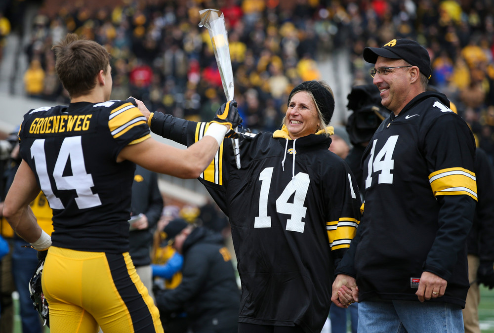 Iowa Hawkeyes wide receiver Kyle Groeneweg (14) is greeted by his parents during Senior Day ceremonies before a game against Nebraska at Kinnick Stadium on November 23, 2018. (Tork Mason/hawkeyesports.com)