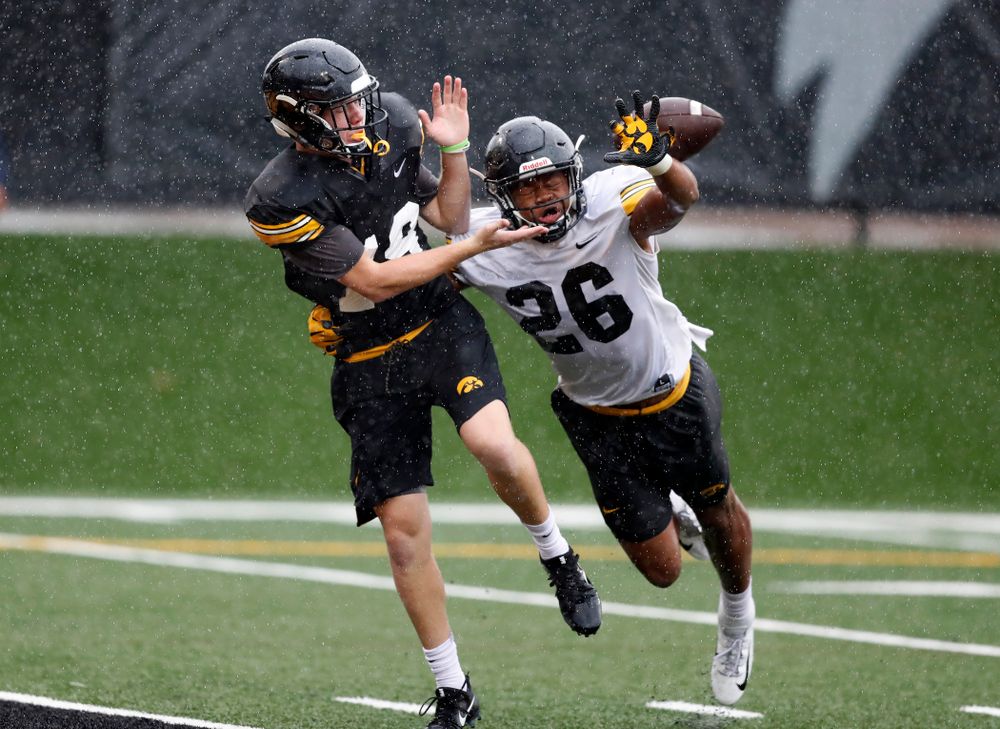 Iowa Hawkeyes wide receiver Max Cooper (19) and defensive back Kaevon Merriweather (26) during camp practice No. 15  Monday, August 20, 2018 at the Hansen Football Performance Center. (Brian Ray/hawkeyesports.com)
