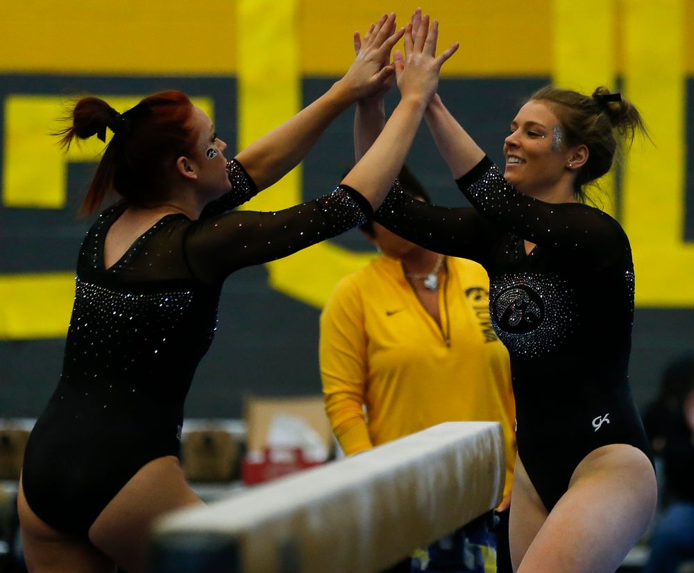 Sydney Hogan celebrates after her balance beam routine during the Black and Gold Intrasquad meet at the Field House on 12/2/17. (Tork Mason/hawkeyesports.com)