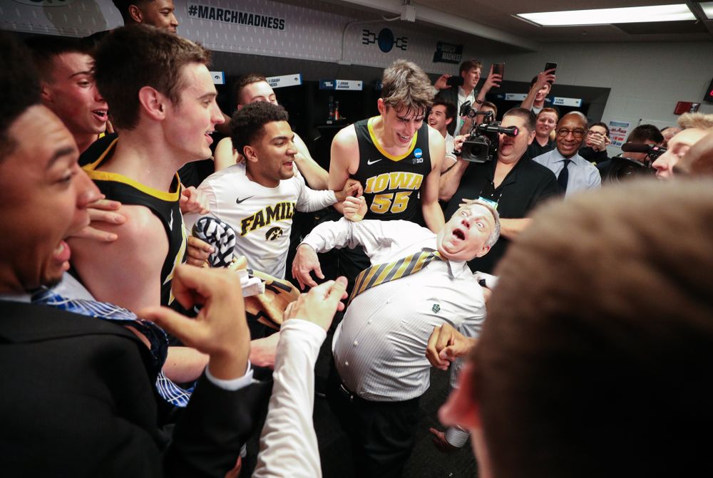Iowa Hawkeyes assistant coach Kirk Speraw dances with the team following their win against the Cincinnati Bearcats in the first round of the 2019 NCAA Men's Basketball Tournament Friday, March 22, 2019 at Nationwide Arena in Columbus, Ohio. (Brian Ray/hawkeyesports.com)