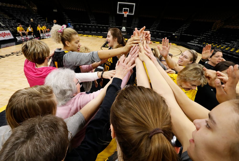 Cancer survivors tell their stories to the Iowa Women's Basketball team following their shoot around  