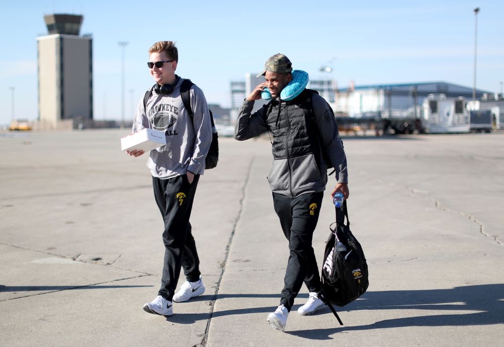 Iowa Hawkeyes quarterback Spencer Petras (7) and wide receiver Ihmir Smith-Marsette (6) board the team plane at the Eastern Iowa Airport Saturday, December 21, 2019 on the way to San Diego, CA for the Holiday Bowl. (Brian Ray/hawkeyesports.com)