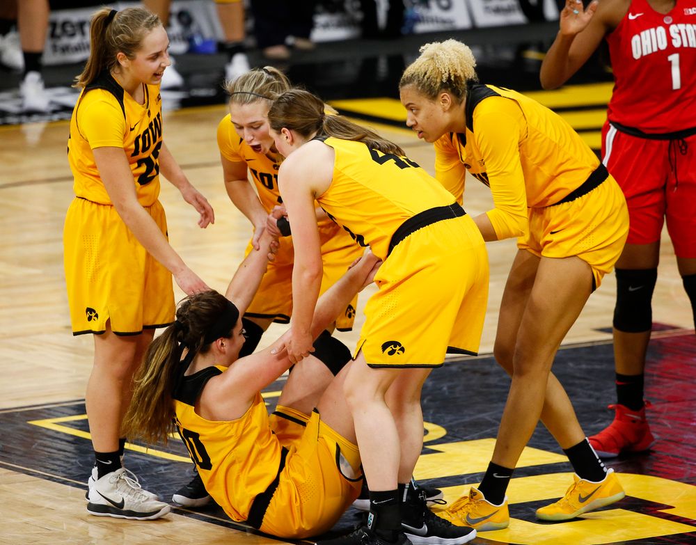 Iowa Hawkeyes forward Megan Gustafson (10) is picked up by her teammates after being fouled during a game against the Ohio State Buckeyes at Carver-Hawkeye Arena on January 25, 2018. (Tork Mason/hawkeyesports.com)