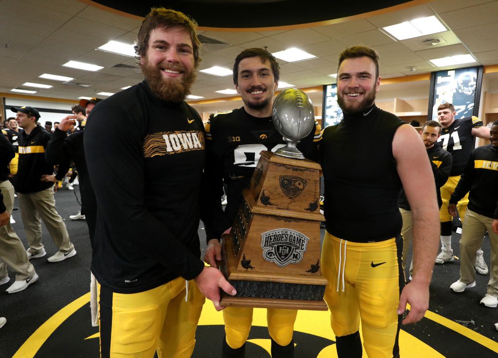 Iowa Hawkeyes long snapper Jackson Subbert (50), place kicker Miguel Recinos (91), and punter Colten Rastetter (7) hold the Heroes game trophy after their game winning field goal against the Nebraska Cornhuskers Friday, November 23, 2018 at Kinnick Stadium. (Brian Ray/hawkeyesports.com)