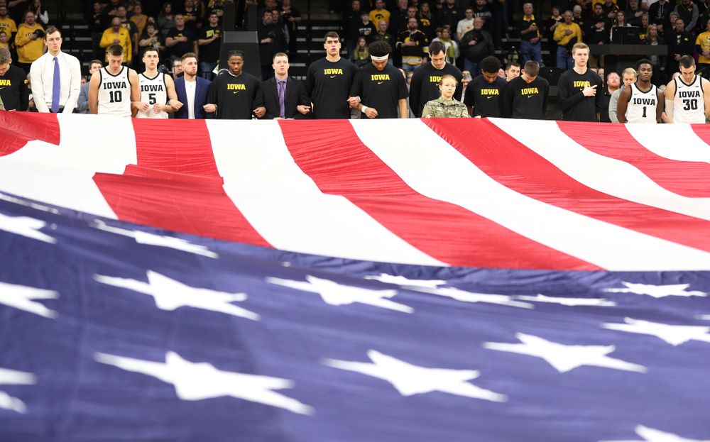 The Iowa Hawkeyes as members of the Iowa Army ROTC display a large American flag before their game against Penn State Saturday, February 29, 2020 at Carver-Hawkeye Arena. (Brian Ray/hawkeyesports.com)
