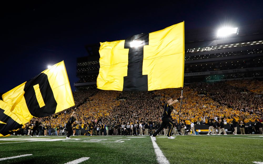 The Iowa Hawkeyes football team swarms the field before a game against Wisconsin at Kinnick Stadium on September 22, 2018. (Tork Mason/hawkeyesports.com)