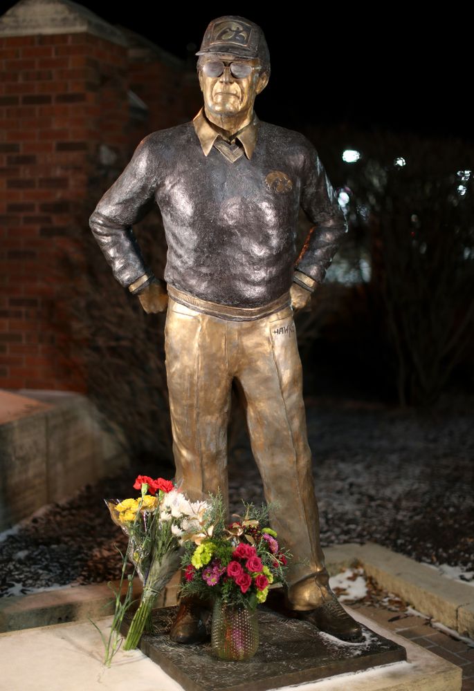 Mourners lay flowers at the statue of former Hawkeye Football Head Coach Hayden Fry Tuesday, December 17, 2019 in Coralville. Fry passed away on Tuesday at the age of 90. (Brian Ray/hawkeyesports.com)