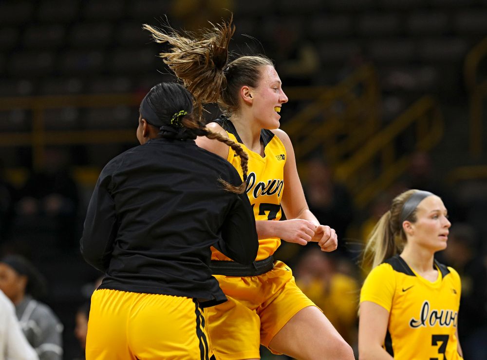 Iowa Hawkeyes forward Amanda Ollinger (43) celebrates with guard Zion Sanders (21) as she makes her way back to the bench during a timeout in the third quarter of their game at Carver-Hawkeye Arena in Iowa City on Thursday, January 23, 2020. (Stephen Mally/hawkeyesports.com)