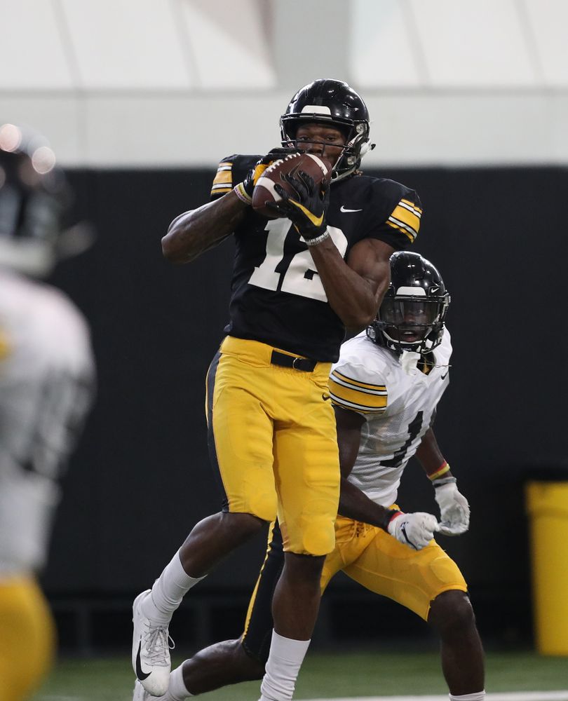Iowa Hawkeyes wide receiver Brandon Smith (12) and defensive back Michael Ojemudia (11) During Fall Camp Practice No. 6 Thursday, August 8, 2019 at the Ronald D. and Margaret L. Kenyon Football Practice Facility. (Brian Ray/hawkeyesports.com)