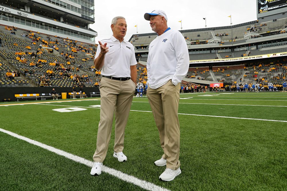 Iowa Hawkeyes head coach Kirk Ferentz (from left) talks with Middle Tennessee State head coach Rick Stockstill before their game at Kinnick Stadium in Iowa City on Saturday, Sep 28, 2019. (Stephen Mally/hawkeyesports.com)