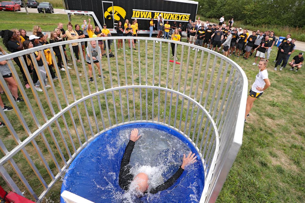 Iowa Baseball assistant coach Robin Lund drops into the water in the dunk tank during the Student-Athlete Kickoff outside the Karro Athletics Hall of Fame Building in Iowa City on Sunday, Aug 25, 2019. (Stephen Mally/hawkeyesports.com)