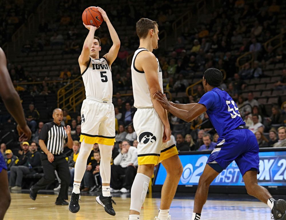 Iowa Hawkeyes guard CJ Fredrick (5) makes a 3-pointer behind forward Jack Nunge (2) during the first half of their exhibition game against Lindsey Wilson College at Carver-Hawkeye Arena in Iowa City on Monday, Nov 4, 2019. (Stephen Mally/hawkeyesports.com)