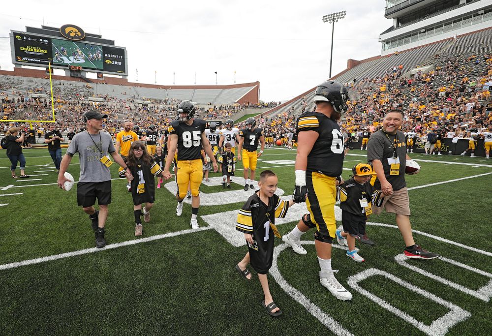 The Kid Captains swarm with Iowa players during Kids Day at Kinnick Stadium in Iowa City on Saturday, Aug 10, 2019. (Stephen Mally/hawkeyesports.com)