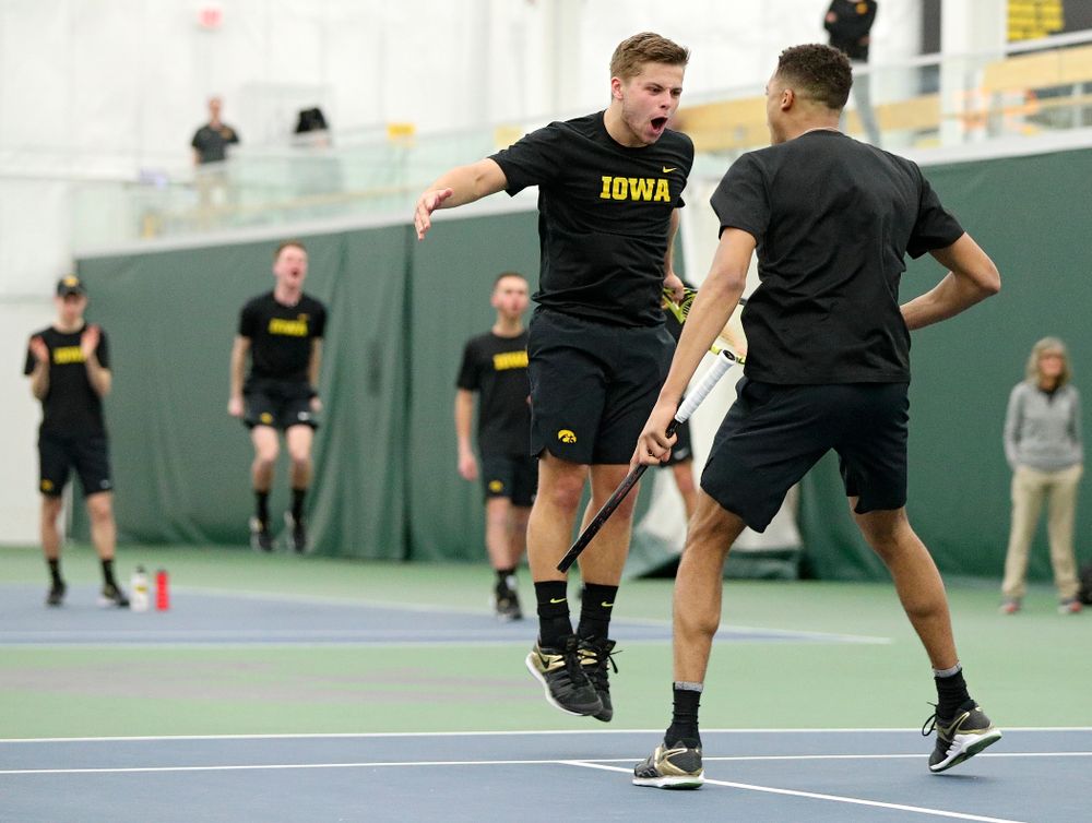 Iowa’s Will Davies (from left) and Oliver Okonkwo celebrate a point during their doubles match at the Hawkeye Tennis and Recreation Complex in Iowa City on Friday, February 14, 2020. (Stephen Mally/hawkeyesports.com)