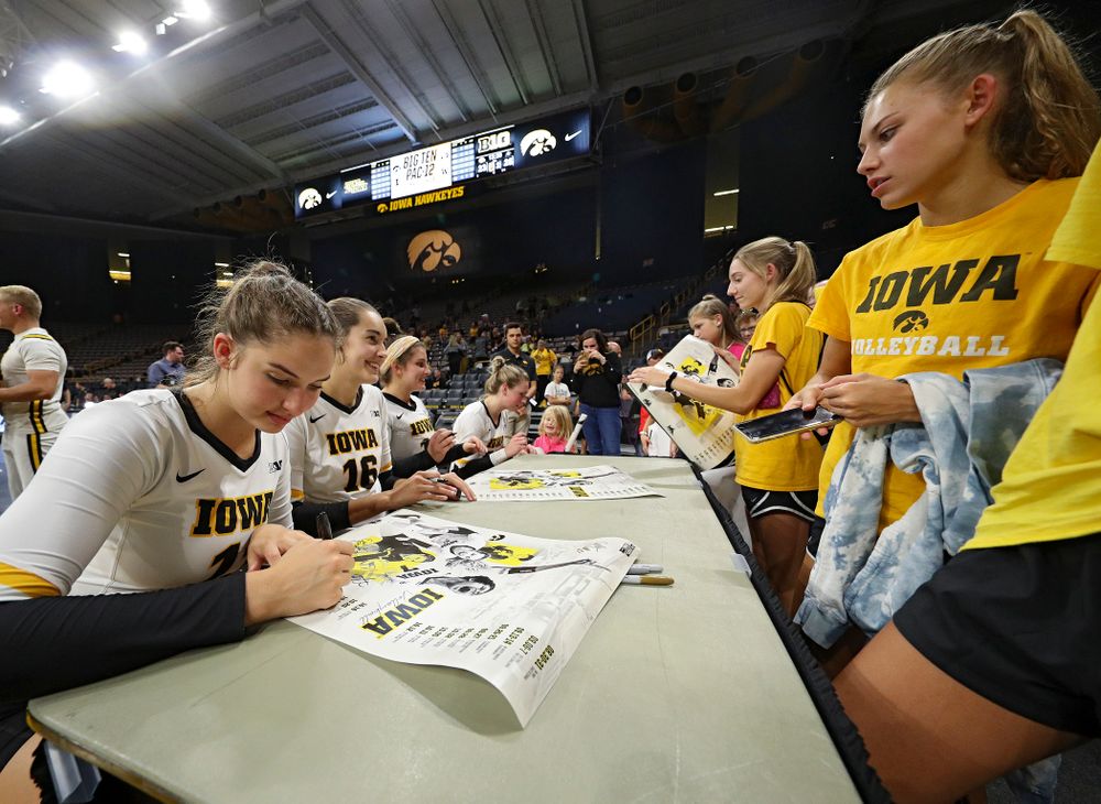 Iowa’s Blythe Rients (11), Grace Tubbs (16), Maddie Slagle (15), and Jaedynn Evans (22) sign autographs after their Big Ten/Pac-12 Challenge match against Colorado at Carver-Hawkeye Arena in Iowa City on Friday, Sep 6, 2019. (Stephen Mally/hawkeyesports.com)
