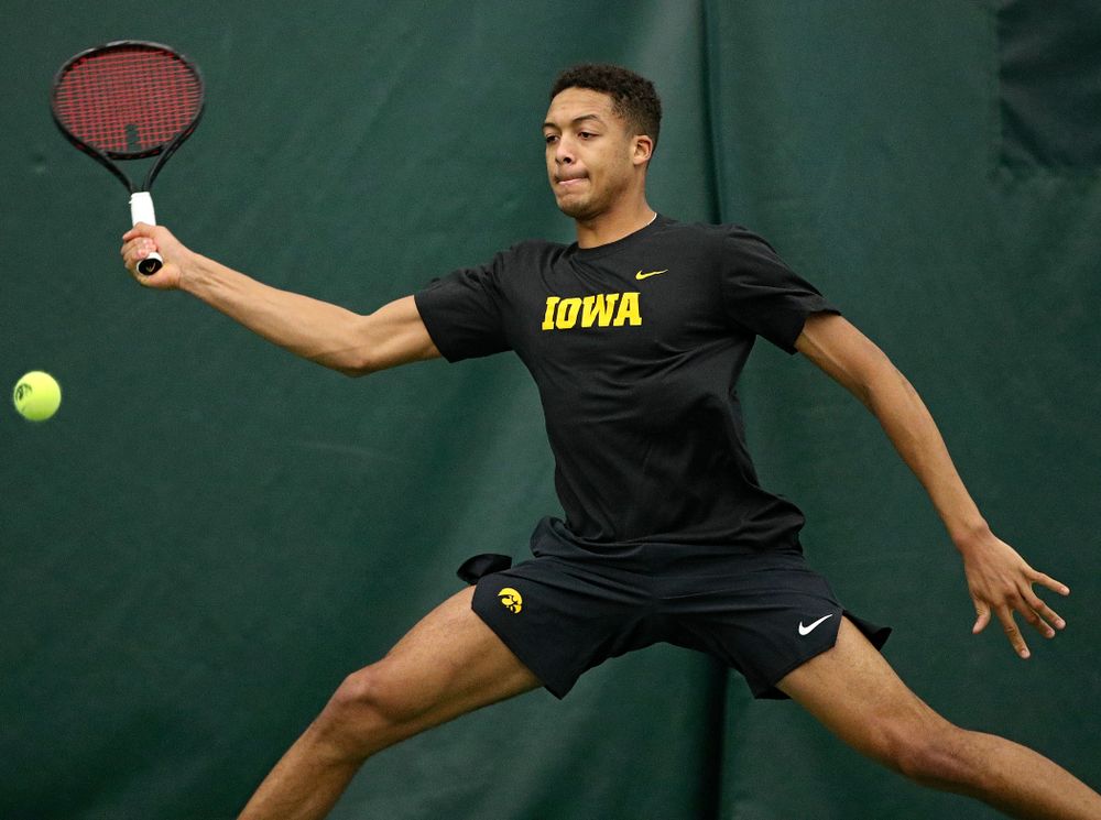 Iowa’s Oliver Okonkwo hits a shot during his match against Marquette at the Hawkeye Tennis and Recreation Complex in Iowa City on Saturday, January 25, 2020. (Stephen Mally/hawkeyesports.com)