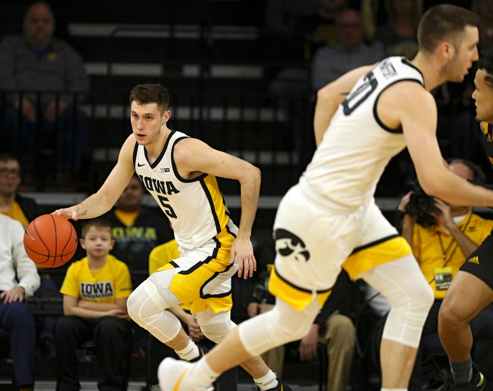 Iowa Hawkeyes guard CJ Fredrick (5) moves with the ball as guard Connor McCaffery (30) heads down court during the first half of their their game at Carver-Hawkeye Arena in Iowa City on Sunday, December 29, 2019. (Stephen Mally/hawkeyesports.com)