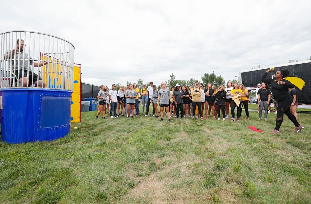 Iowa thrower Laulauga Tausaga tries to sink assistant coach Eric Werskey in the dunk tank during the Student-Athlete Kickoff outside the Karro Athletics Hall of Fame Building in Iowa City on Sunday, Aug 25, 2019. (Stephen Mally/hawkeyesports.com)