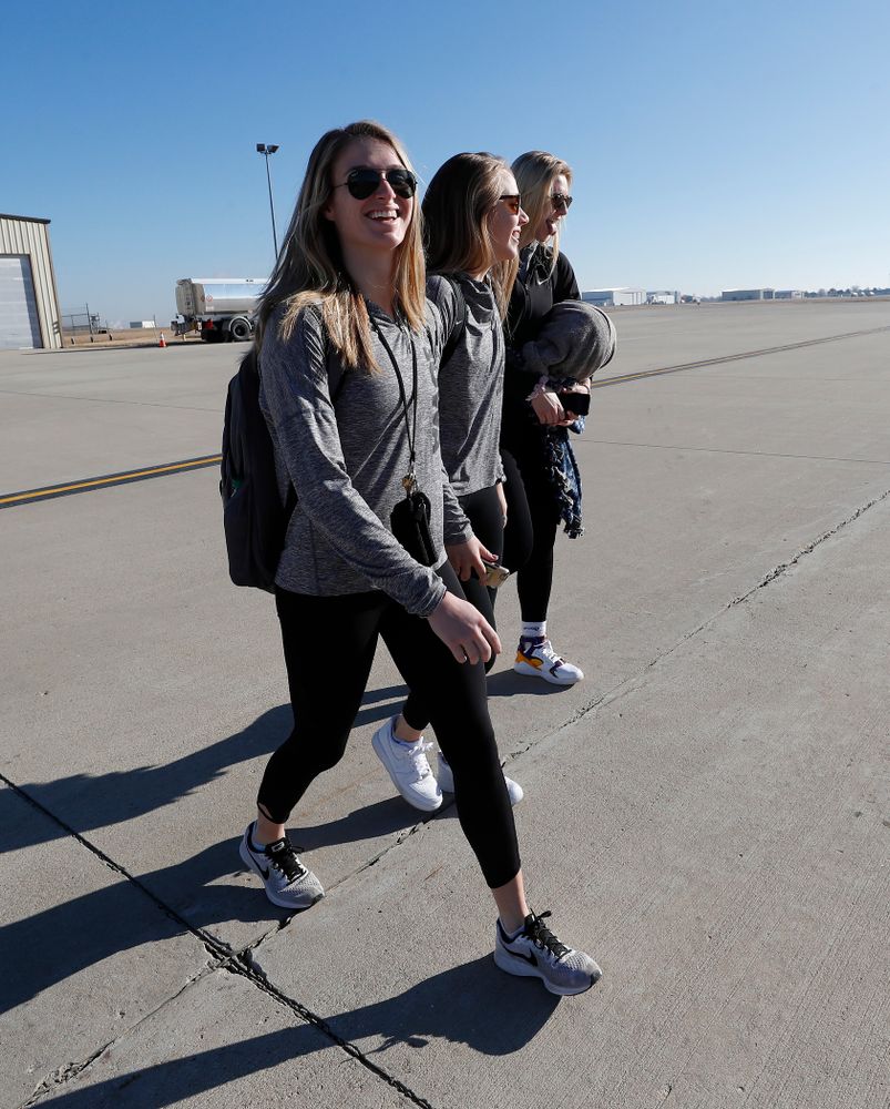 Iowa Hawkeyes guard Makenzie Meyer (3), guard Kathleen Doyle (22), and forward Hannah Stewart (21) walk to the team's plane as they travel to Los Angeles for the first round of the 2018 NCAA Tournament Thursday, March 15, 2018 at the Eastern Iowa Airport. (Brian Ray/hawkeyesports.com)