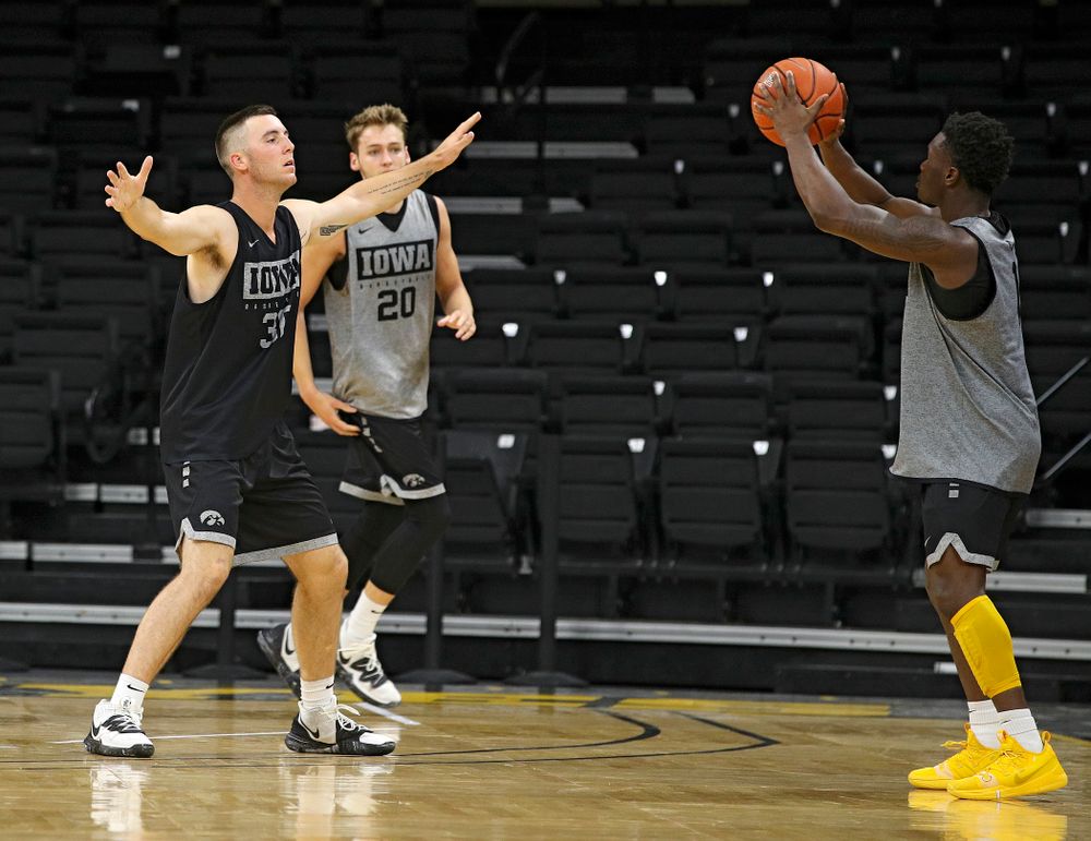 Iowa Hawkeyes guard Joe Toussaint (1) looks to pass around guard Connor McCaffery (30) during practice at Carver-Hawkeye Arena in Iowa City on Monday, Sep 30, 2019. (Stephen Mally/hawkeyesports.com)