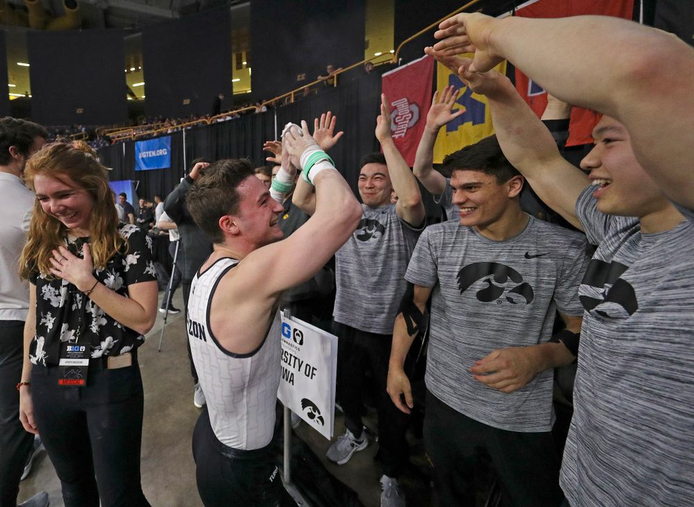 Iowa's Jake Brodarzon celebrates with teammates after competing in the rings during the second day of the Big Ten Men's Gymnastics Championships at Carver-Hawkeye Arena in Iowa City on Saturday, Apr. 6, 2019. (Stephen Mally/hawkeyesports.com)