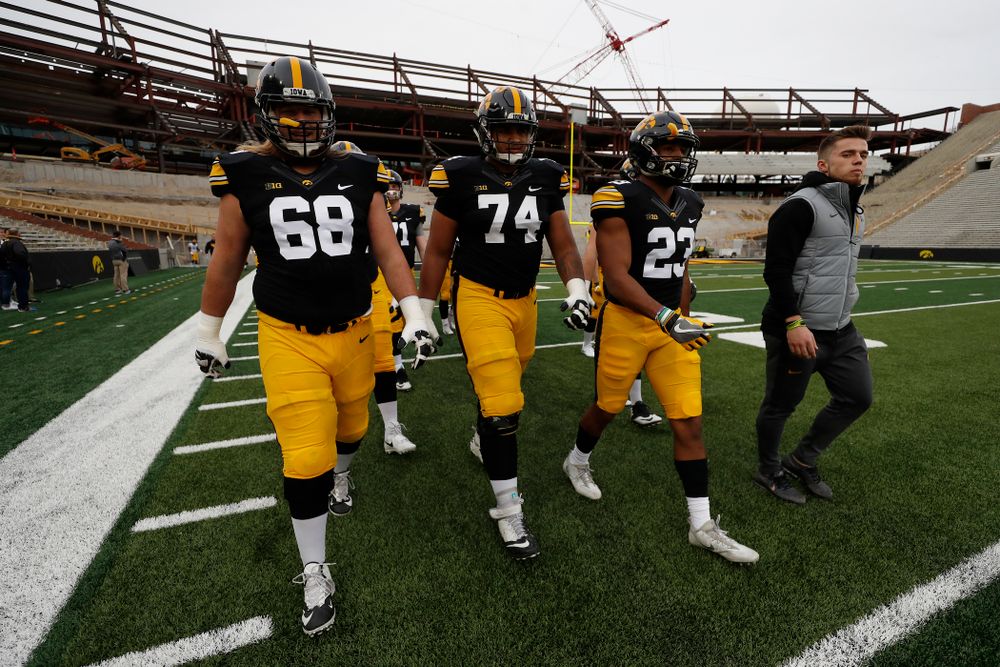 Iowa Hawkeyes offensive lineman Landan Paulsen (68), offensive lineman Tristan Wirfs (74), and wide receiver Dominique Dafney (23) during the final spring practice Friday, April 20, 2018 at Kinnick Stadium. (Brian Ray/hawkeyesports.com)