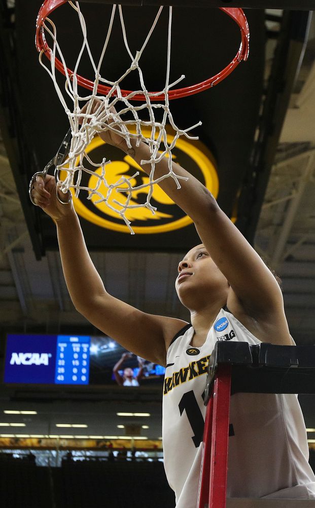 Iowa Hawkeyes guard Tania Davis (11) cuts down the net after winning their second round game in the 2019 NCAA Women's Basketball Tournament at Carver Hawkeye Arena in Iowa City on Sunday, Mar. 24, 2019. (Stephen Mally for hawkeyesports.com)