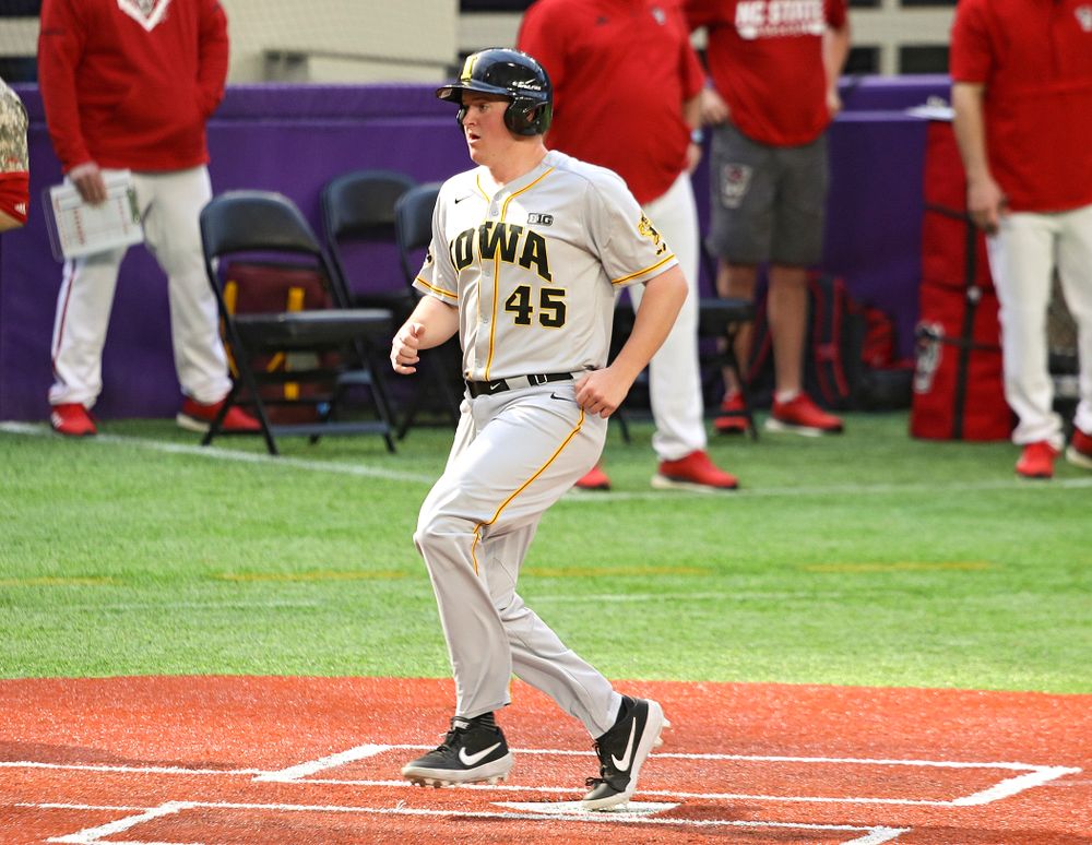 Iowa Hawkeyes first baseman Peyton Williams (45) scores a run during the seventh inning of their CambriaCollegeClassic game at U.S. Bank Stadium in Minneapolis, Minn. on Friday, February 28, 2020. (Stephen Mally/hawkeyesports.com)