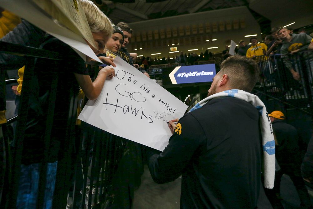 Iowa Hawkeyes guard Jordan Bohannon (3) signs an autograph for a fan during Iowa men’s basketball vs SIUE on Friday, November 8, 2019 at Carver-Hawkeye Arena. (Lily Smith/hawkeyesports.com)