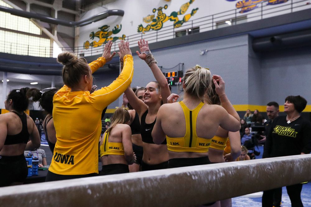 Allie Gilchrist (center) hjigh fives teammates during the Iowa women’s gymnastics Black and Gold Intraquad Meet on Saturday, December 7, 2019 at the UI Field House. (Lily Smith/hawkeyesports.com)