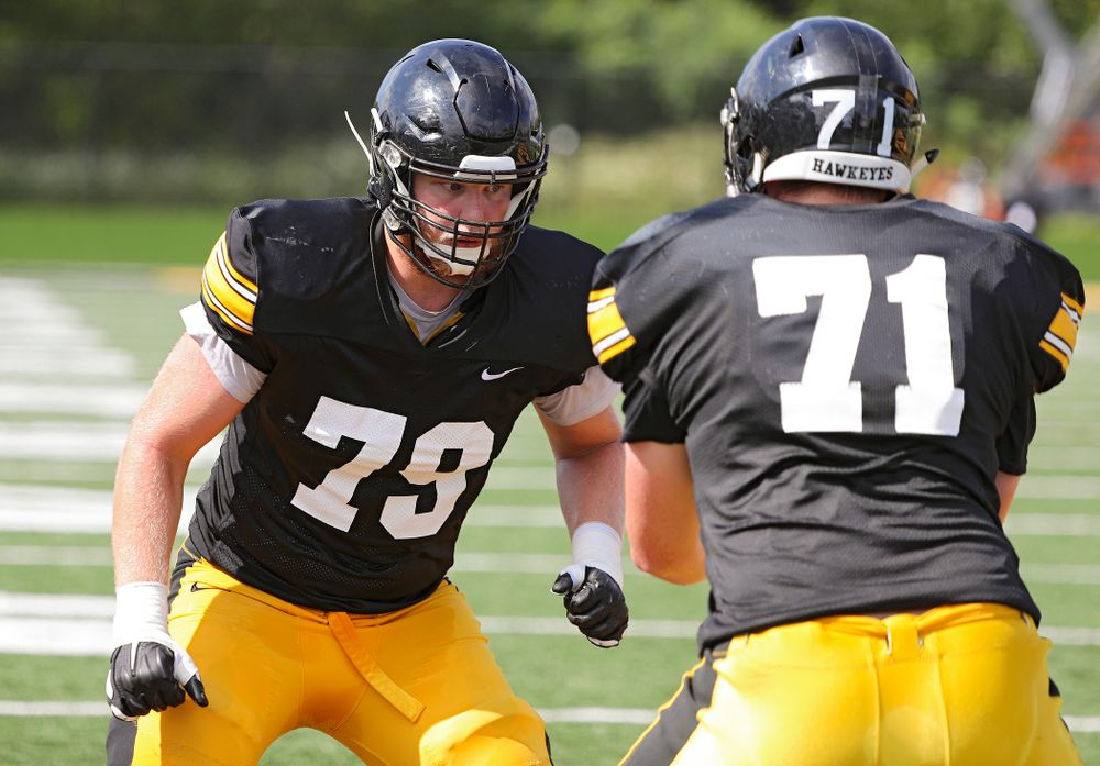 Iowa Hawkeyes offensive lineman Jack Plumb (79) runs a drill with offensive lineman Mark Kallenberger (71) during Fall Camp Practice No. 11 at the Hansen Football Performance Center in Iowa City on Wednesday, Aug 14, 2019. (Stephen Mally/hawkeyesports.com)