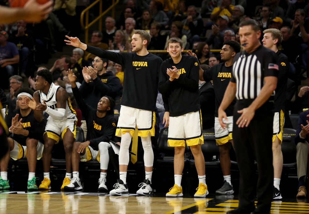 Iowa Hawkeyes forward Riley Till (20) and guard Austin Ash (13) celebrate a three point basket against the Minnesota Golden Gophers Monday, December 9, 2019 at Carver-Hawkeye Arena. (Brian Ray/hawkeyesports.com)