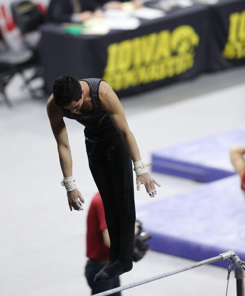 Iowa's Andrew Herrador competes on the high bar against Oklahoma Saturday, February 9, 2019 at Carver-Hawkeye Arena. (Brian Ray/hawkeyesports.com)