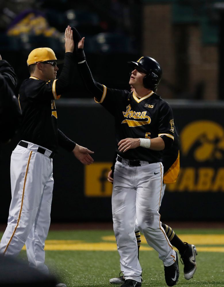 Iowa Hawkeyes catcher Tyler Cropley (5) high fives catcher Austin Guzzo (20) after scoring against the Bradley Braves Wednesday, March 28, 2018 at Duane Banks Field. (Brian Ray/hawkeyesports.com)