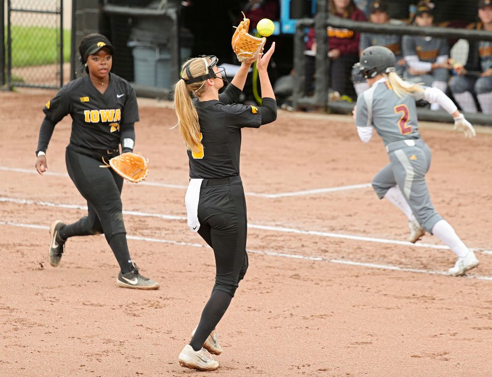 Iowa pitcher Allison Doocy (3) pulls in a pop up for an out as DoniRae Mayhew (24) looks on during the fourth inning of their game against Iowa Softball vs Indian Hills Community College at Pearl Field in Iowa City on Sunday, Oct 6, 2019. (Stephen Mally/hawkeyesports.com)