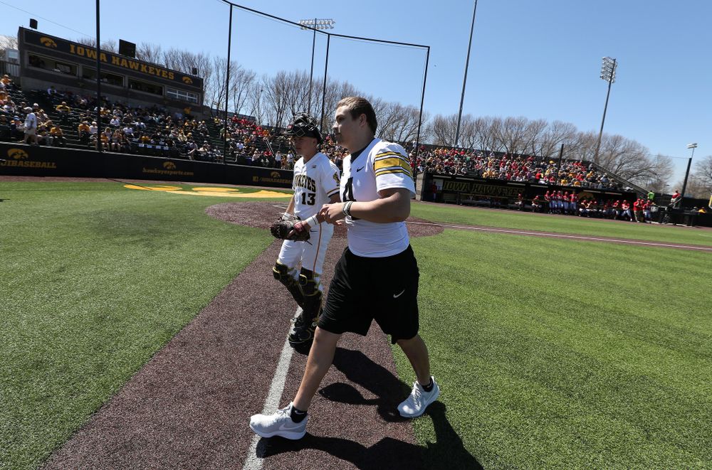 Iowa Hawkeyes quarterback Nate Stanley (4) throws out a first pitch against the Nebraska Cornhuskers Saturday, April 20, 2019 at Duane Banks Field. (Brian Ray/hawkeyesports.com)