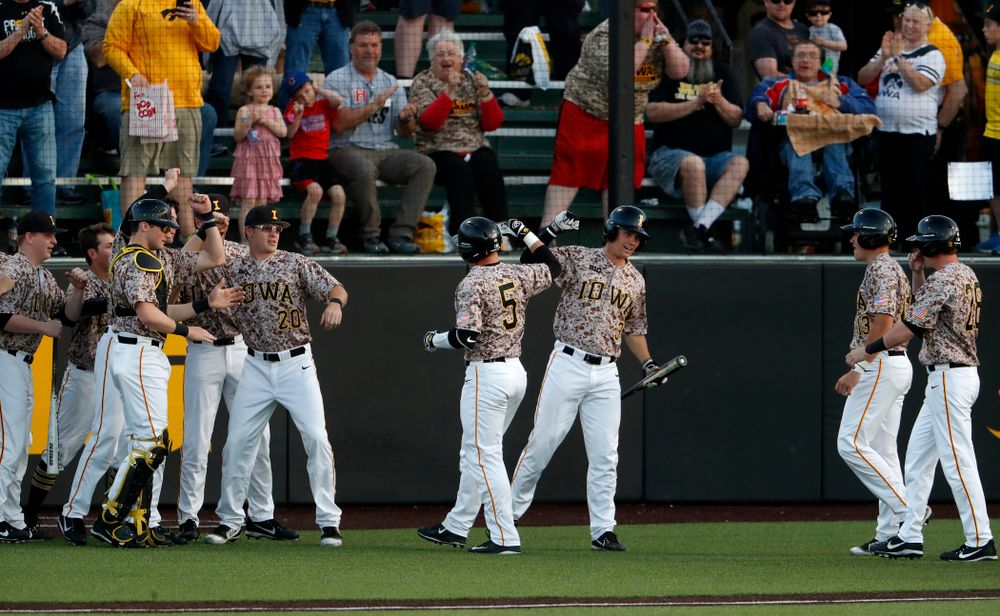 Iowa Hawkeyes catcher Tyler Cropley (5) celebrates with infielder Matt Hoeg (3) after hitting a home run against Oklahoma State Friday, May 4, 2018 at Duane Banks Field. (Brian Ray/hawkeyesports.com)