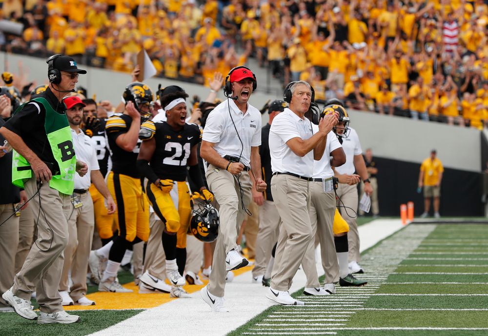 Iowa Hawkeyes head coach Kirk Ferentz  and offensive student assistant Declan Doyle celebrate a touchdown against the Northern Illinois Huskies Saturday, September 1, 2018 at Kinnick Stadium. (Brian Ray/hawkeyesports.com)