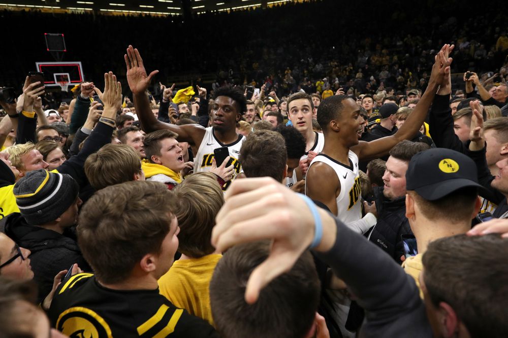Iowa Hawkeyes guard Maishe Dailey (1) and forward Tyler Cook (25) celebrate with fans after defeating the Michigan Wolverines  Friday, February 1, 2019 at Carver-Hawkeye Arena. (Brian Ray/hawkeyesports.com)