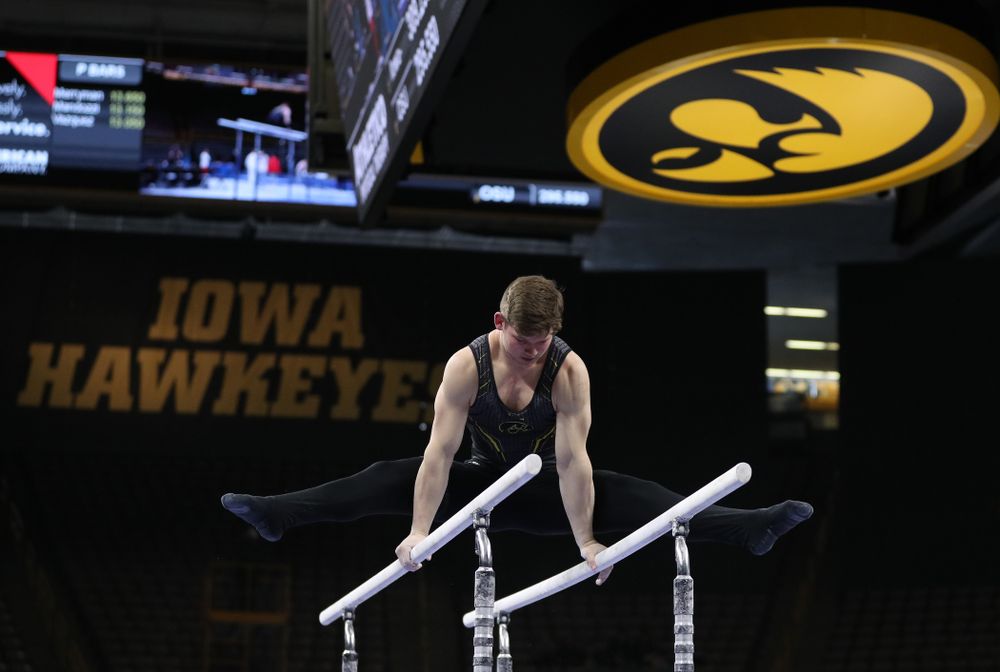 Iowa's Stewart Brown competes on the parallel bars against the Ohio State Buckeyes  Saturday, March 16, 2019 at Carver-Hawkeye Arena.  (Brian Ray/hawkeyesports.com)