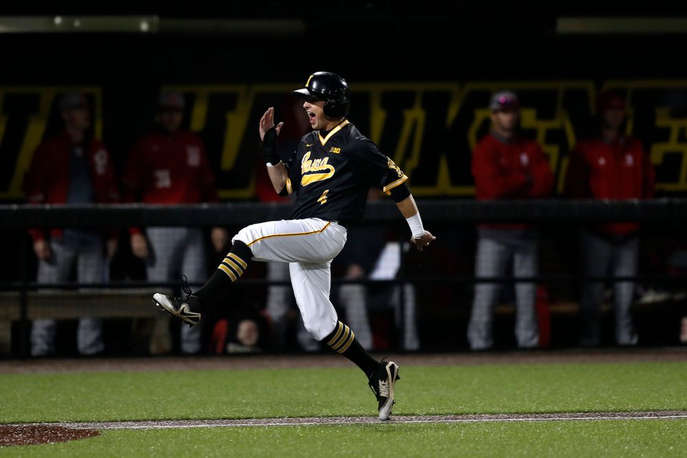 Iowa Hawkeyes infielder Mitchell Boe (4) celebrates as he scores on a walk off grand slam by catcher Tyler Cropley (5) in the bottom of the ninth against the Bradley Braves Wednesday, March 28, 2018 at Duane Banks Field. (Brian Ray/hawkeyesports.com)