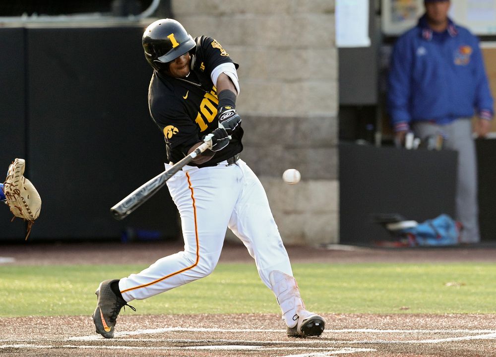 Iowa infielder Izaya Fullard (20) hits a sacrifice fly during the fourth inning of their college baseball game at Duane Banks Field in Iowa City on Tuesday, March 10, 2020. (Stephen Mally/hawkeyesports.com)