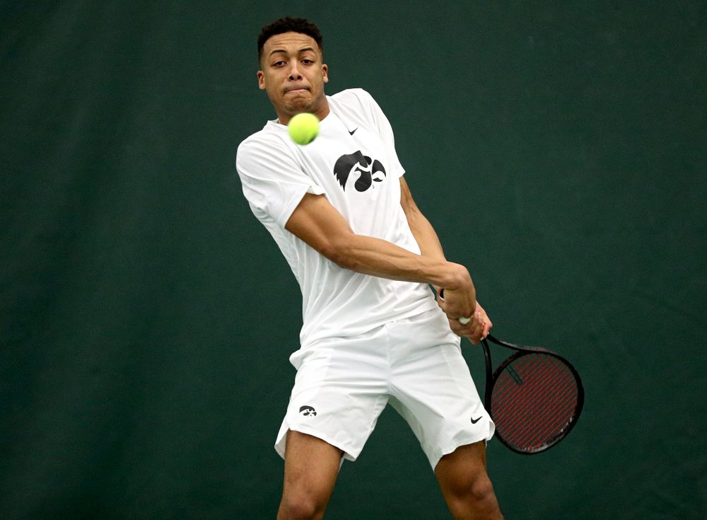 Iowa’s Oliver Okonkwo returns a shot during his singles match at the Hawkeye Tennis and Recreation Complex in Iowa City on Sunday, February 16, 2020. (Stephen Mally/hawkeyesports.com)