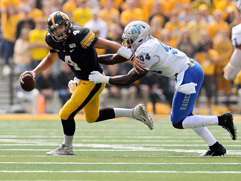 Iowa Hawkeyes quarterback Nate Stanley (4) pulls away from a defender during the second quarter of their game at Kinnick Stadium in Iowa City on Saturday, Sep 28, 2019. (Stephen Mally/hawkeyesports.com)