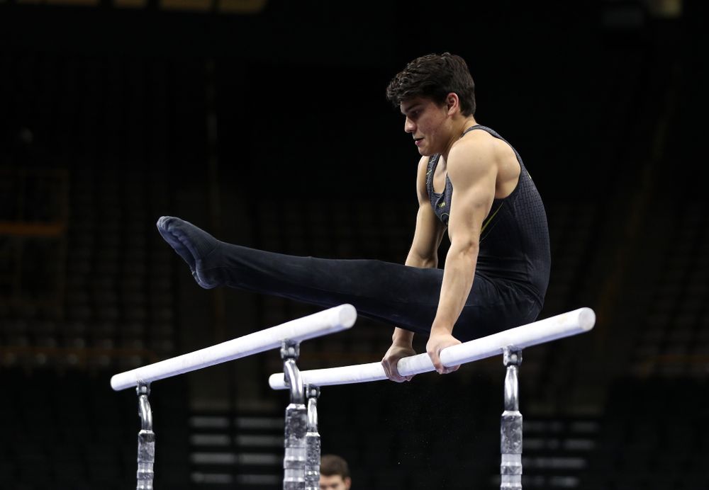 Iowa's Evan Davis competes on the parallel bars against the Ohio State Buckeyes  Saturday, March 16, 2019 at Carver-Hawkeye Arena.  (Brian Ray/hawkeyesports.com)