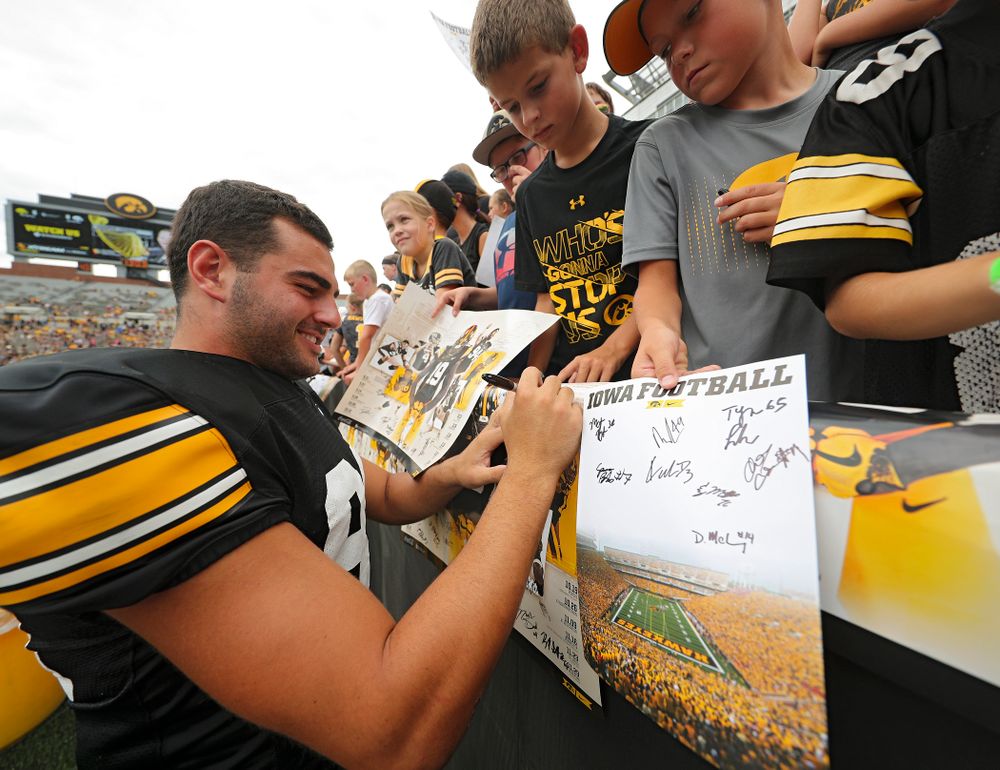 Iowa Hawkeyes wide receiver Nico Ragaini (89) signs an autograph during Kids Day at Kinnick Stadium in Iowa City on Saturday, Aug 10, 2019. (Stephen Mally/hawkeyesports.com)
