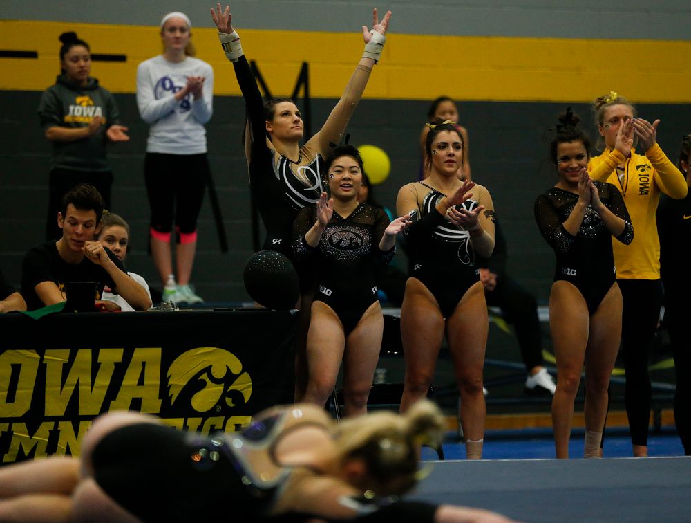 Iowa gymnasts react during Charlotte Sullivan's floor routine during the Black and Gold Intrasquad meet at the Field House on 12/2/17. (Tork Mason/hawkeyesports.com)